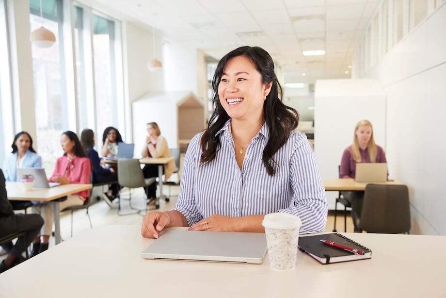 Woman sitting at desk smiling