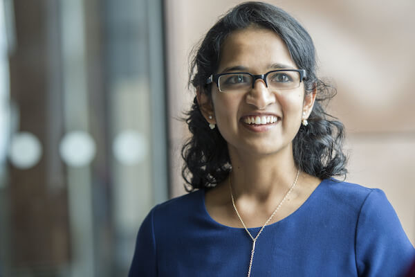 a women wearing glasses looks past the camera