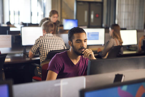 A young student sits in a computer lab at SAIT.